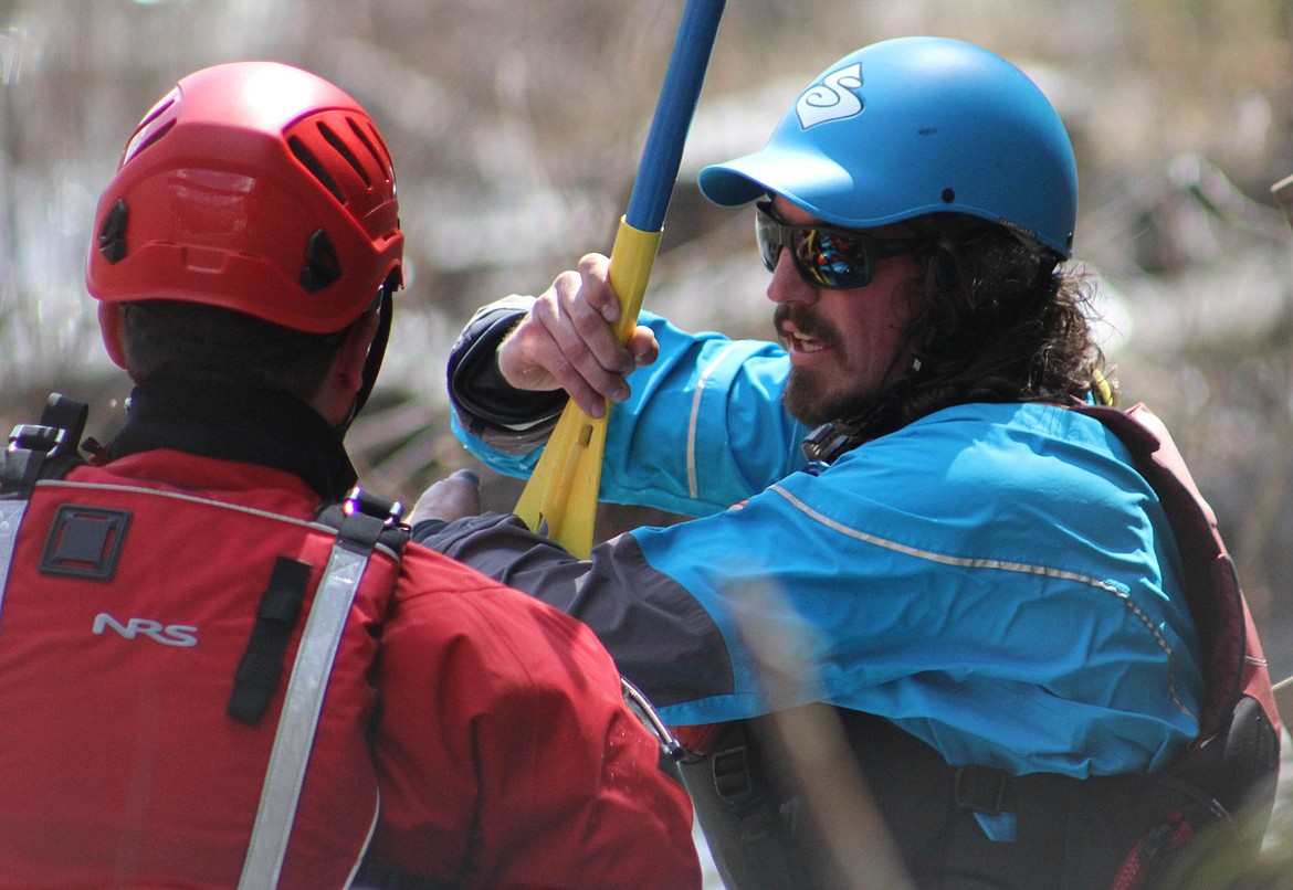 WRI INSTRUCTOR Britt Thiessen shows paddlers correct safety and paddling techniques at the Cyr boat launch on May 10 during the Swiftwater Rescue Technician course.