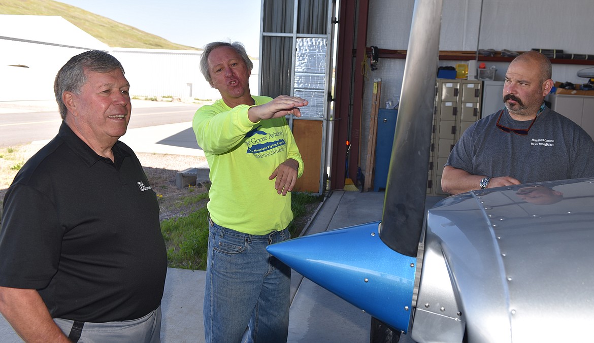 DEAN McGINNIS, left, and Josh Conatser listen to Blue Goose Aviation co-owner Joe Kuberka during last Saturday&#146;s &#147;Learn to Fly&#148; introduction at the Polson Airport. Both McGinnis and Conatser are planning to pursue getting a pilot&#146;s license. (Joe Sova photos/Lake County Leader)