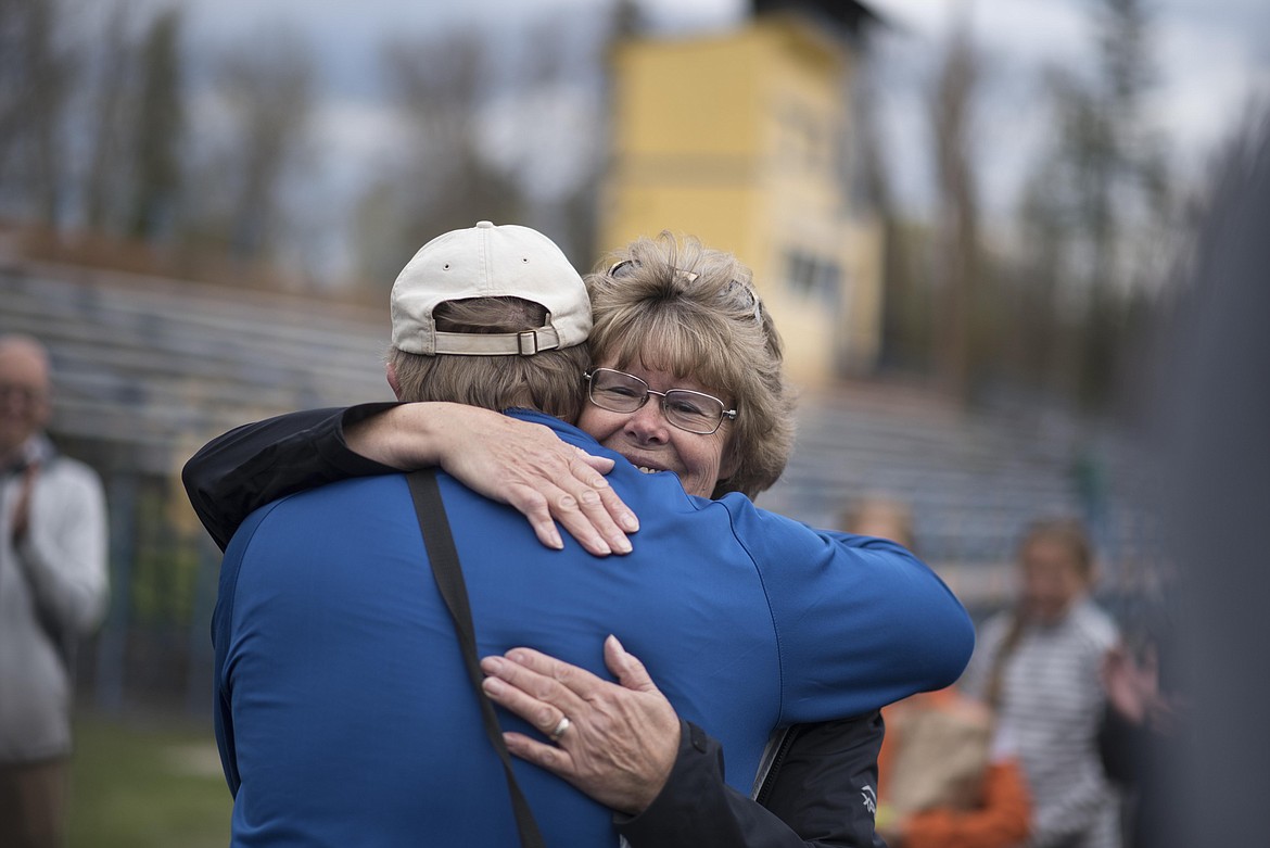 Head Coach Jim May, Libby High School track and field, left, hugs Marge Kroeger to thank her for her years of coaching work at the end of the 4th and 5th grade Mini Meet, Thursday, May 2 at Libby High School. (Luke Hollister/The Western News)
