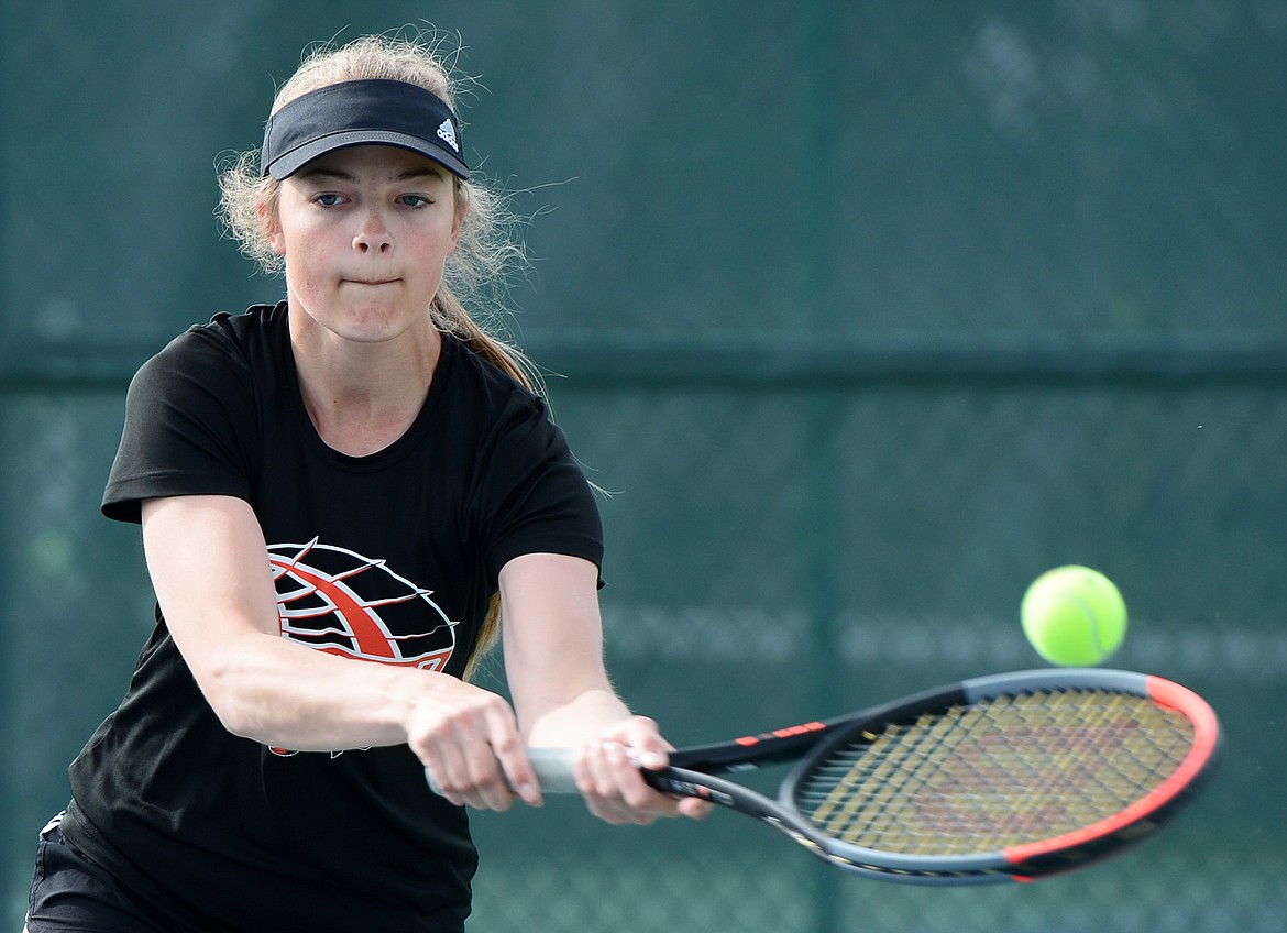 Flathead's Kendall Pyron hits a return in a doubles match with teammate Emma Hawkins against Glacier's Hannah Nikunen and Ashlyn Sliter during the Northern AA Divisional at Flathead Valley Community College on Friday. (Casey Kreider/Daily Inter Lake)