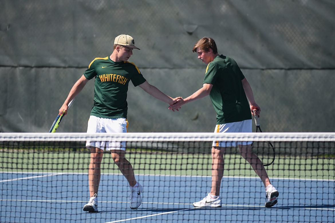 Mark Anderson and Colter Upton high five after a point against Corvallis on Saturday at FVCC. (Daniel McKay/Whitefish Pilot)