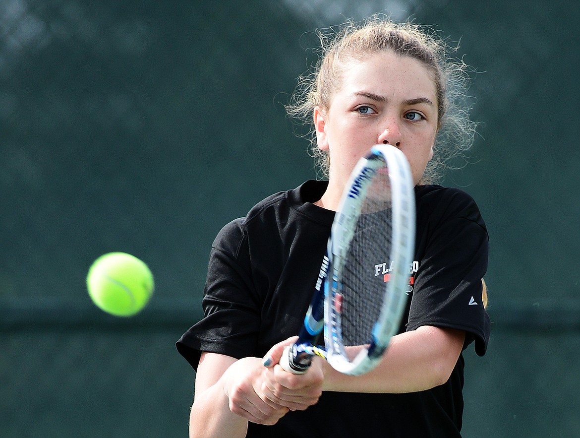 Flathead's Emma Hawkins hits a return in a doubles match with teammate Kendall Pyron against Glacier's Hannah Nikunen and Ashlyn Sliter during the Northern AA Divisional at Flathead Valley Community College on Friday. (Casey Kreider/Daily Inter Lake)