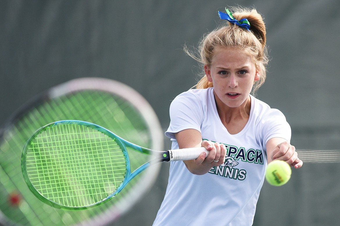 Glacier's Hannah Nikunen hits a return in a doubles match with teammate Ashlyn Sliter against Flathead's Emma Hawkins and Kendall Pyron at the Northern AA Divisional at Flathead Valley Community College on Friday. (Casey Kreider/Daily Inter Lake)