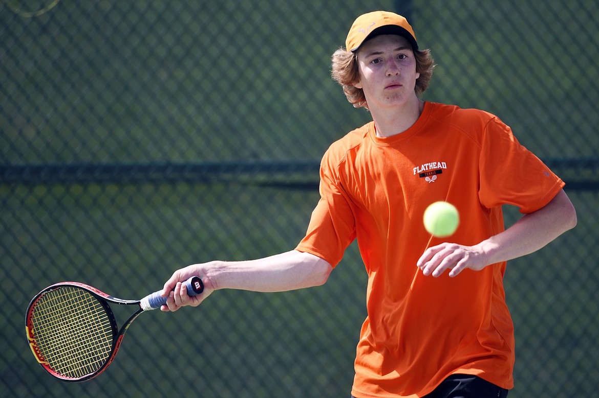 Flathead's Joston Cripe hits a return against Glacier's Rory Smith in the championship match of the Northern AA Divisionals at Flathead Valley Community College on Friday. (Casey Kreider/Daily Inter Lake)