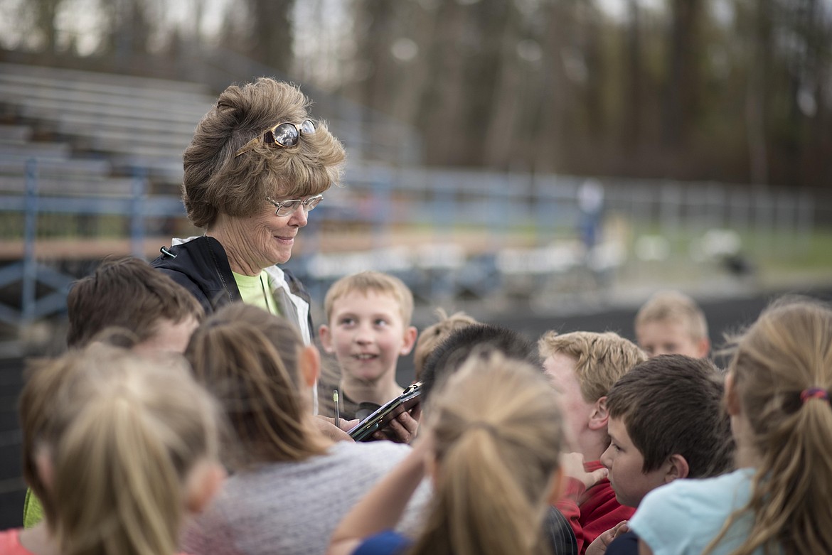 Coach Marge Kroeger leads students during the 4th and 5th grade Mini Meet, Thursday, May 2 at Libby High School. (Luke Hollister/The Western News)