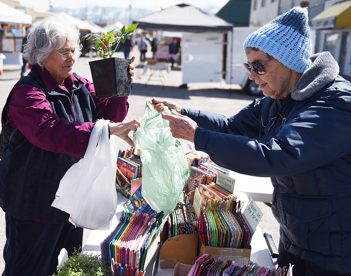 BARBARA COULSON of Ye Olde Treadle Shoppe bags plants for Mary Sale during the first Polson Farmers Market of the 2019 season. The market is offering more veggies, herbs and other items each week from 9 a.m. to 1 p.m. each Friday on 3rd Avenue West, in front of The Cove Deli &amp; Pizza.