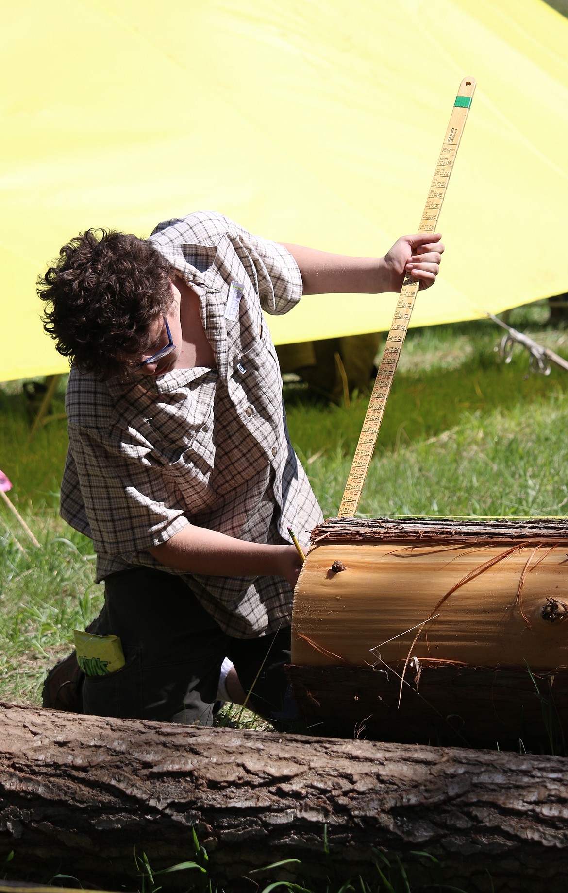 (Photo by MARY MALONE)
A Sandpoint High School student measures a log at the junior/senior division scaling station during the Idaho State Forestry Contest on Thursday at Delay Farms in Careywood.