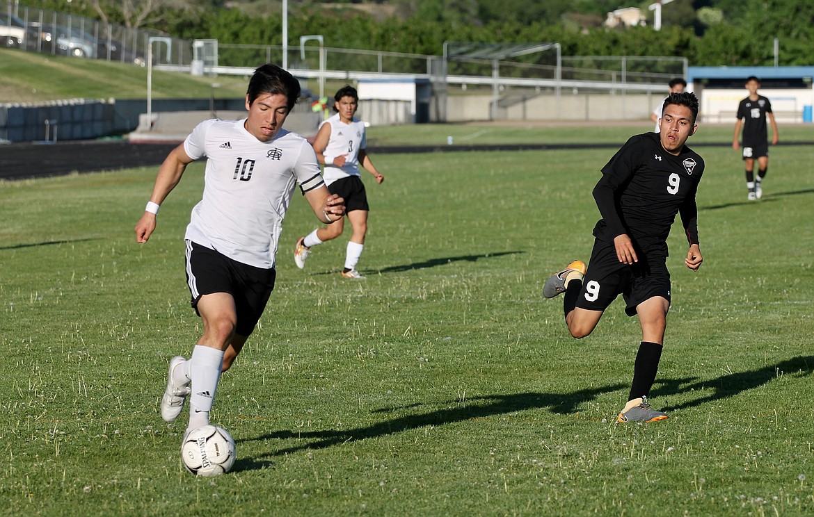 Casey McCarthy/ The Sun Tribune  
Royal midfielder Alonso Hernandez drives towards the goal against Wahluke defender Marcos Castro in the first half of the district championship on Thursday in Naches.  Wahluke won the match 1-0.