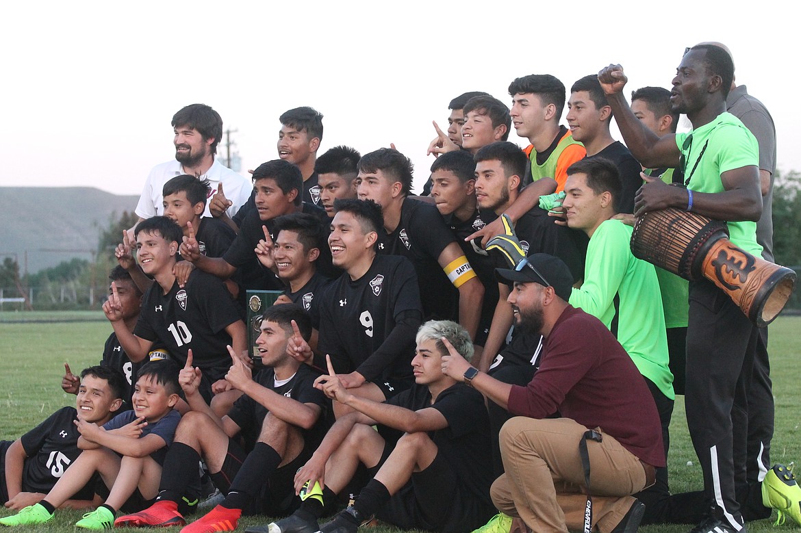 Casey McCarthy/ The Sun Tribune
The Wahluke soccer team poses for a picture after being presented the trophy for winning the District championship on Thursday at Naches Valley High School.