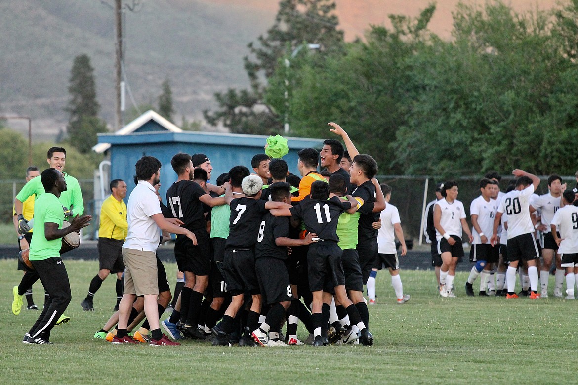 Casey McCarthy/ The Sun Tribune  
Wahluke soccer team celebrates after defeating Royal 1-0 to claim the SCAC District championship on Thursday in Naches.