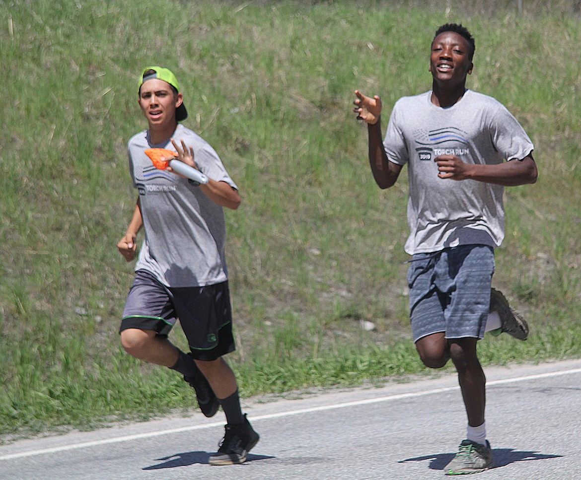 TWO RUNNERS from the Mountain Meadow Youth Ranch take part in the LETR for Special Olympics.