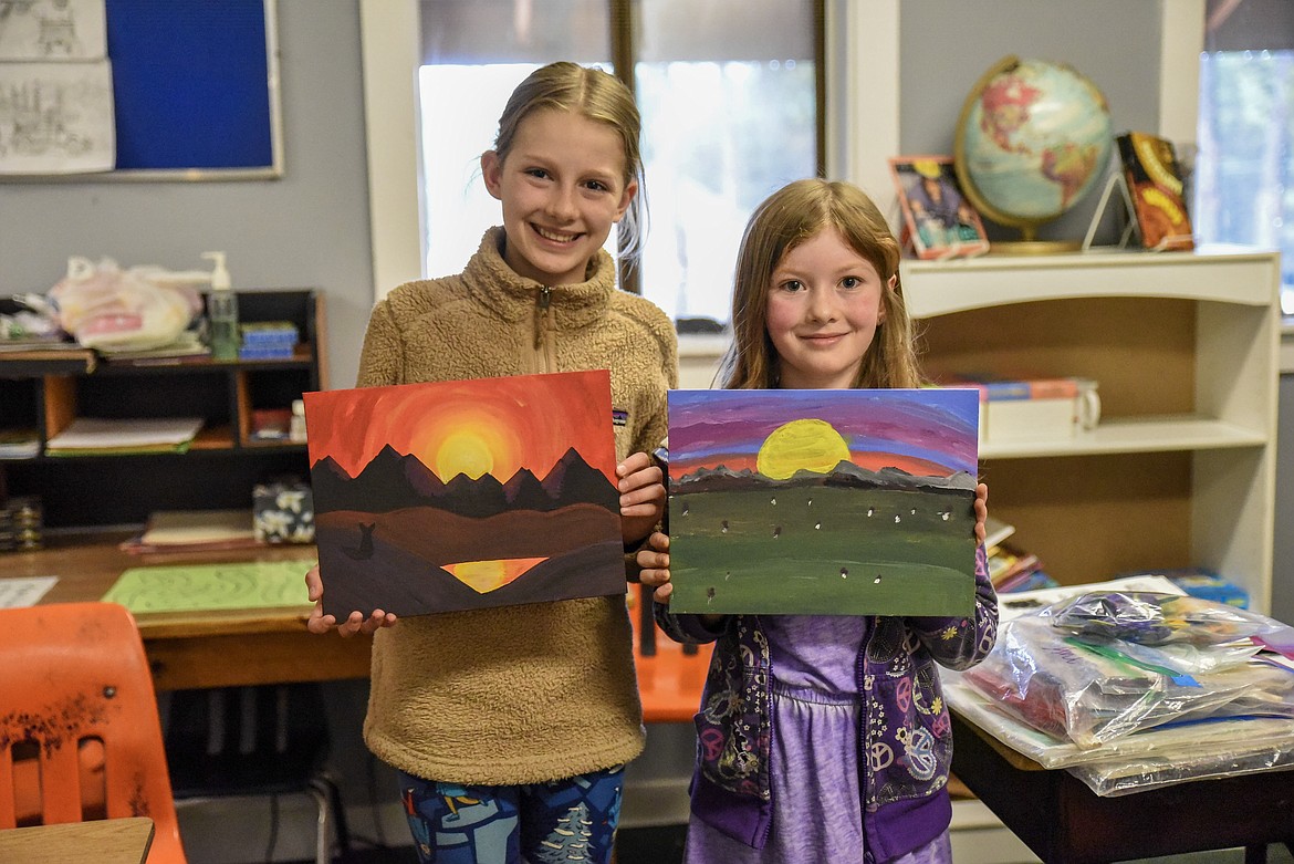 Yaak School students Ani Vick, 5th grade, and Jasmine Bilbrey, 3rd grade, both took second place for northwest Montana with entries in the 2019 Keep Montana Green Poster Contest. Their submitted art was not returned, but they each chose a favorite artwork they have done to pose with. The theme they painted for the contest was to increase awareness of wildfires and their causes. Vick painted a picture looking up into a forest from the ground, with fire consuming the trees. Bilbery painted a picture of people evacuating a house threatened by fire, as well as campers running from their tent in the midst of a fire. Both said that their paintings were inspired in part by their experiences living in the Yaak. (Ben Kibbey/The Western News)