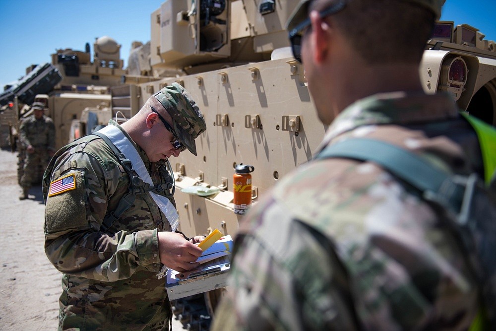 Idaho Army National Guard 1st Lt. Jermey Raush and 1st Lt. Tyler June, engineer officers with the 116th Brigade Engineer Battalion, 116th Cavalry Brigade Combat Team, make a plan to get their platoon of Bradley Fighting Vehicles&#146; Multiple Integrated Laser Engagement System equipment installed May 25, 2019, at the National training Center at Fort Irwin, Calif. The 116th Cavalry Brigade Combat Team is training at the NTC May 24 to June 20 to prepare for its wartime missions.