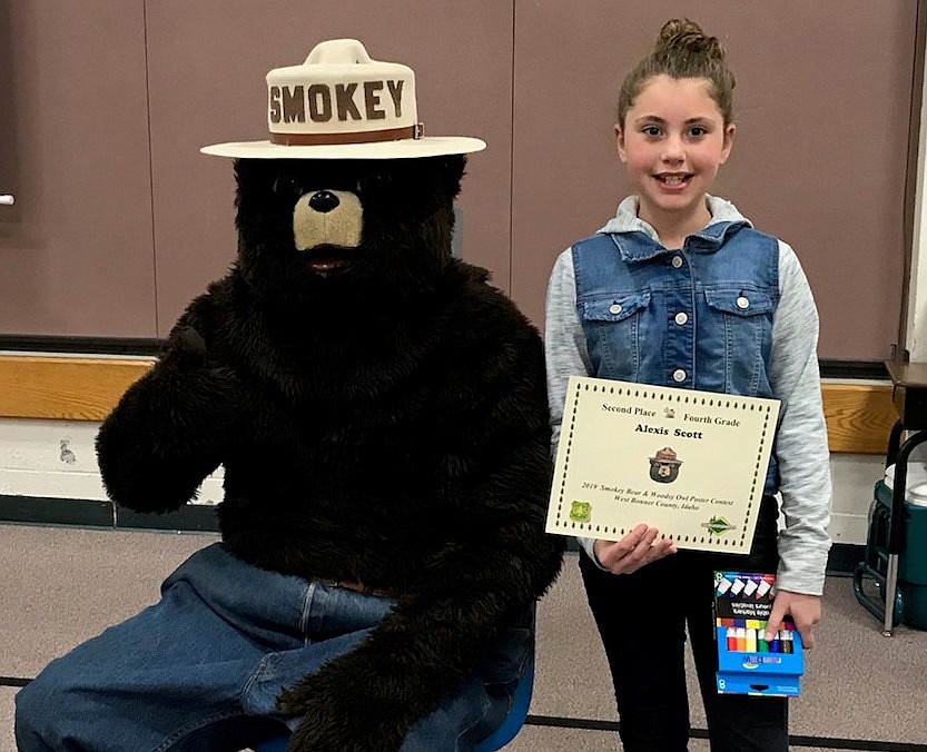 (Photo courtesy PAM AUNUN)Alexis Scott poses with Smokey Bear after winning second-place honors for her poster in the Idaho Department of Lands annual contest.