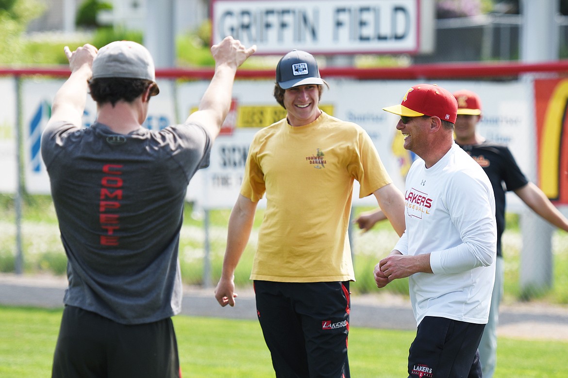 Kalispell Lakers AA head coach Ryan Malmin jokes with the team as they stretch at the start of practice at Griffin Field on Wednesday. (Casey Kreider/Daily Inter Lake)