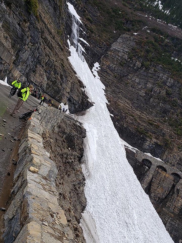 Cyclists stop at an avalanche across Going-to-the-Sun Road at Triple Arches in Glacier National Park on Monday. (GNP photo)