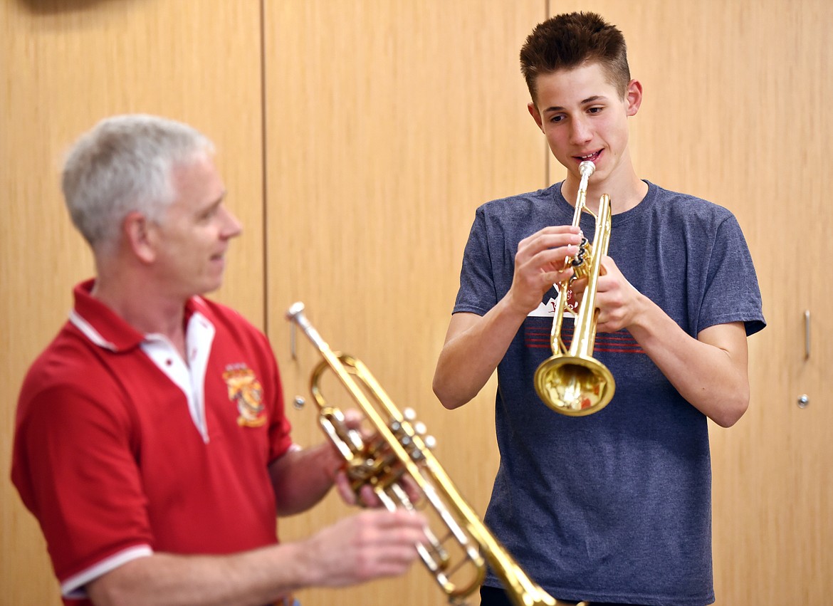 Dale Relyea, 13, of Bigfork, with United States Marine veteran Timothy &quot;Merk&quot; Merklinger, 55, at Flathead Valley Community College on Monday, May 20. Relyea began working with Merklinger 5 weeks ago to learn to play Taps so he could help with military funerals and other functions.(Brenda Ahearn/Daily Inter Lake)