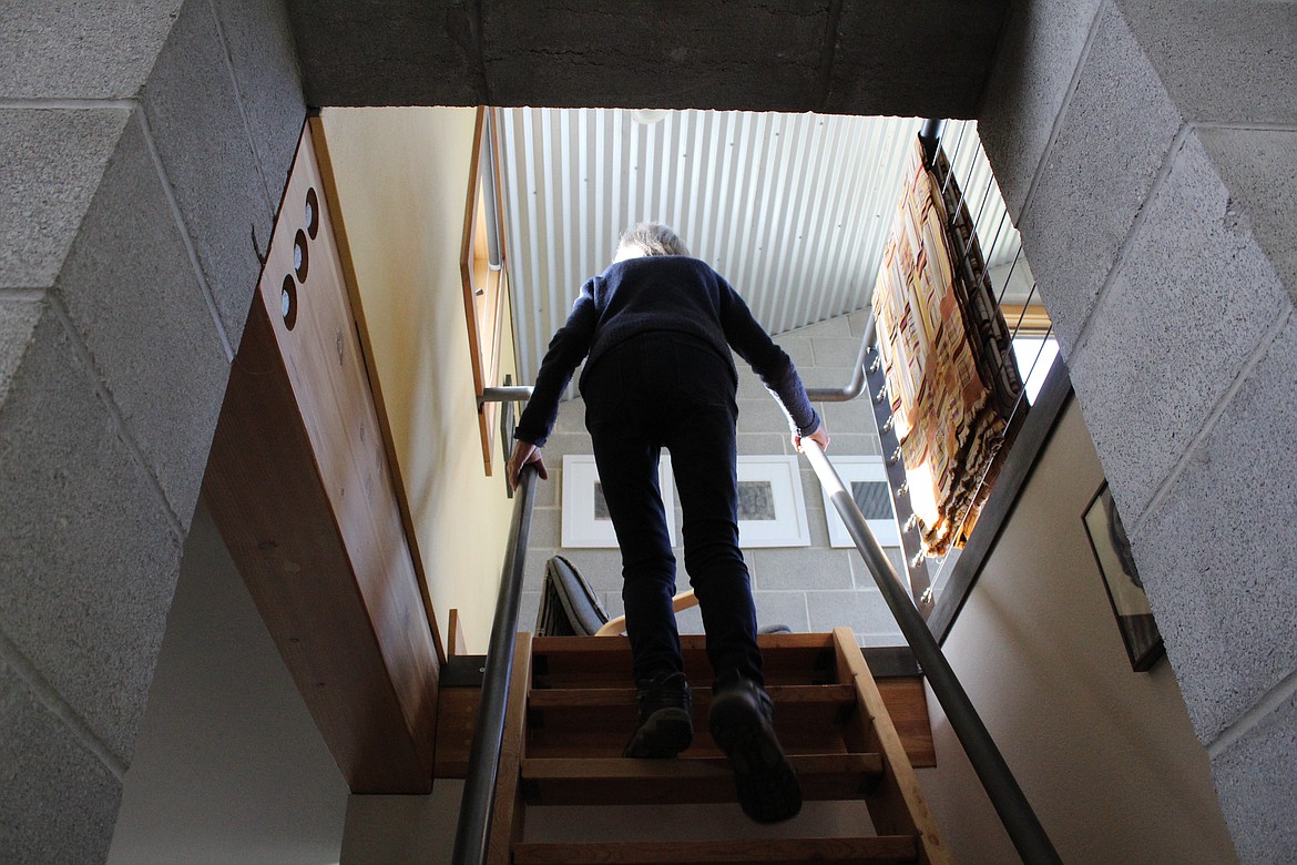 Molly Shepherd climbs the stairs to the &#145;tower&#146; in the wildfire-resistant home she built in the North Fork about 16 miles north of Polebridge.