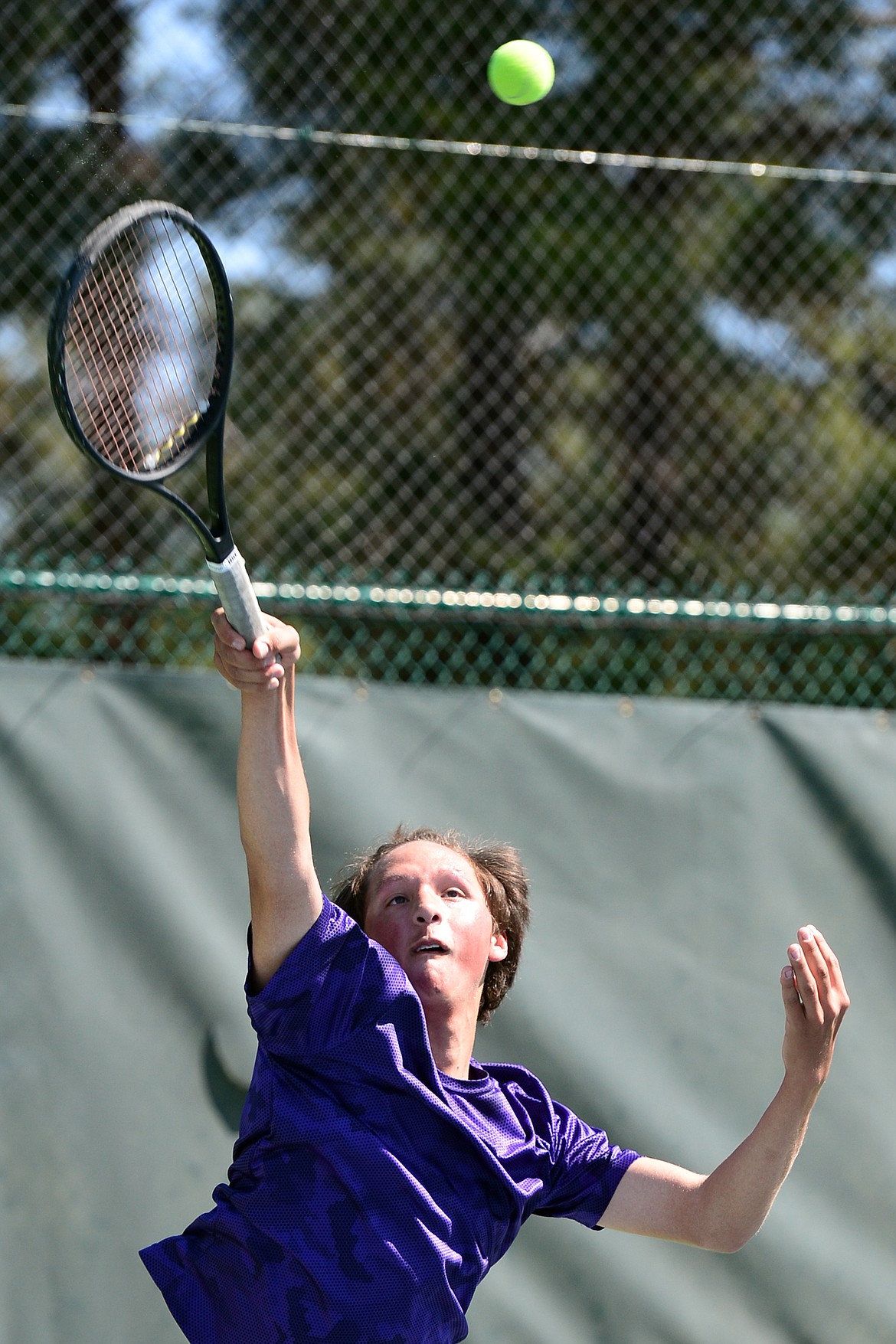 Polson&#146;s Joe McDonald serves in a boys&#146; singles match against Glendive&#146;s Ethan Carney at the Class A State Tennis Tournament at Flathead Valley Community College on Thursday. (Casey Kreider/Daily Inter Lake)