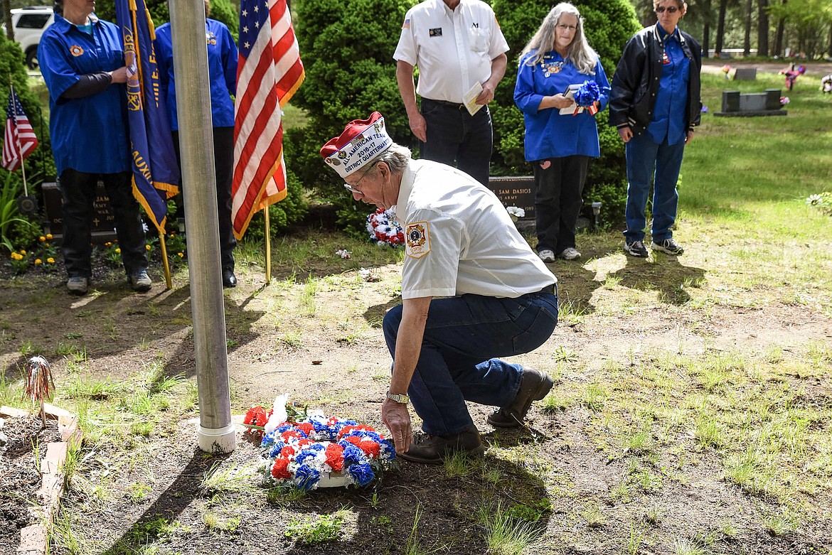 Jerry Erickson, Troy VFW Post 1548 officer of the day, places a wreath as a symbol of remembrance, during the Memorial Day service at Milner Lake Cemetery. (Ben Kibbey/The Western News)