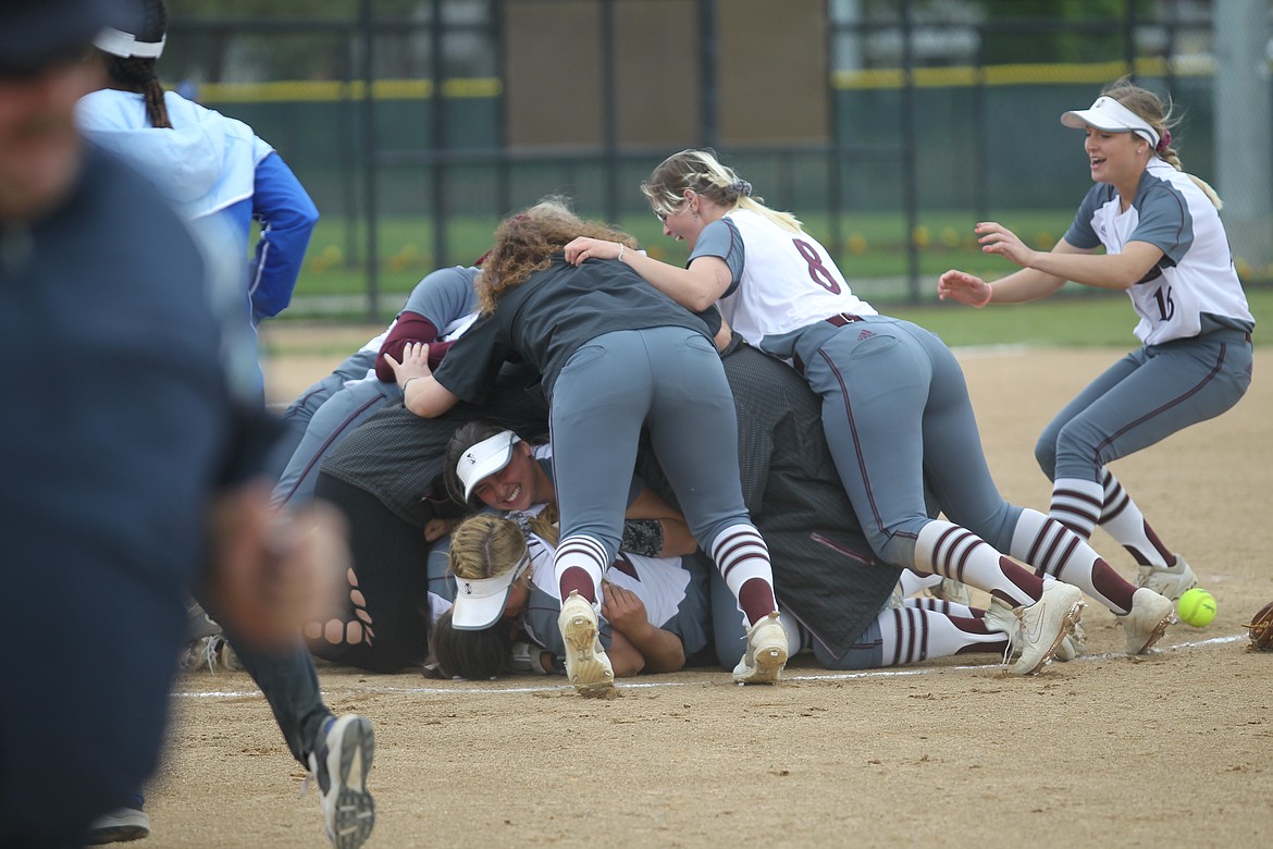 MARK NELKE/Press
North Idaho College players dogpile after beating Edmonds on Monday to win the Northwest Athletic Conference softball championship at the Dwight Merkel Sports Complex in Spokane.