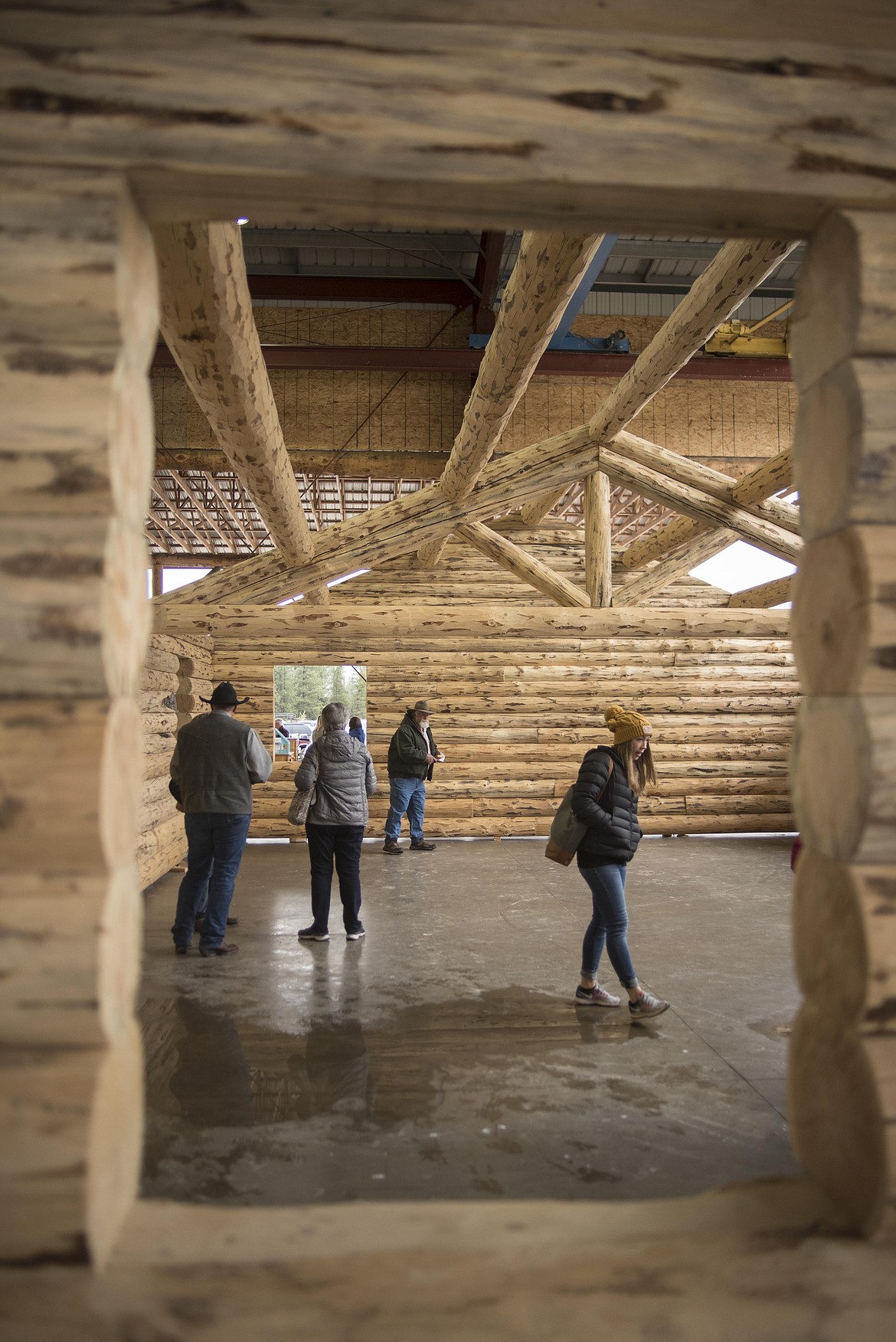 Attendees look at log homes for sale during the annual amish Eagle Valley Community Auction, May 18. (Luke Hollister/The Western News)