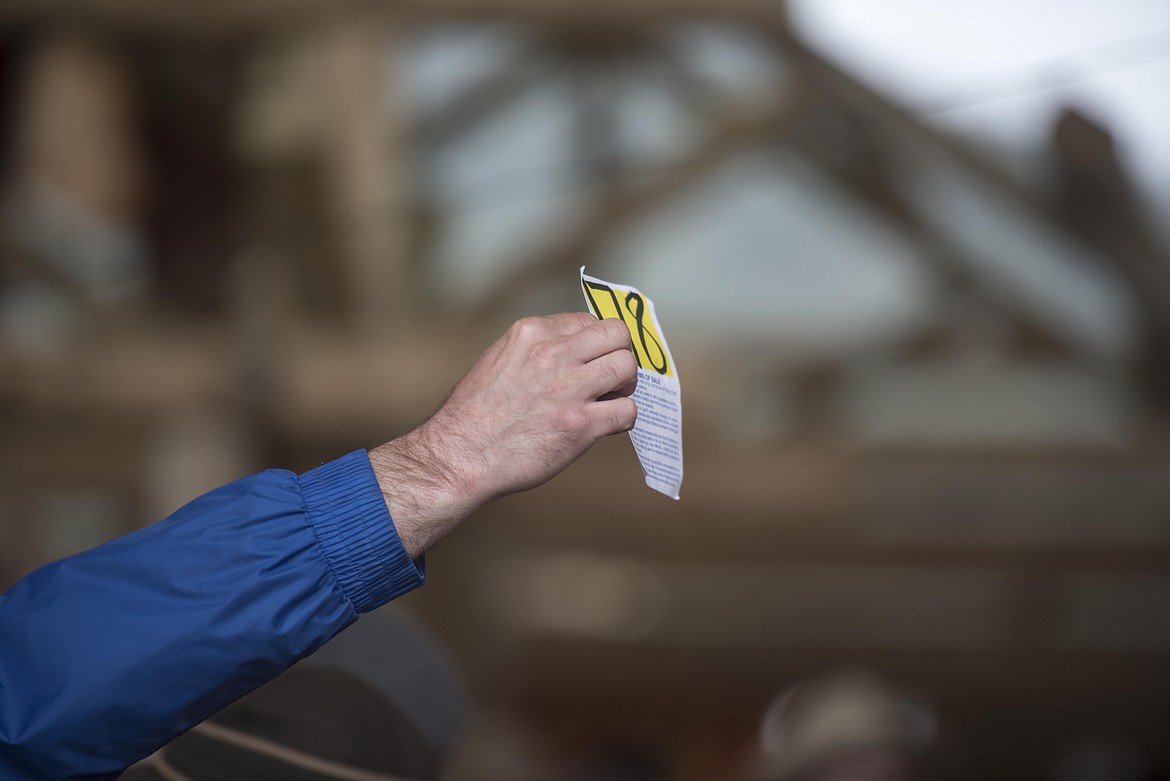 An attendee raises a bid during the annual amish Eagle Valley Community Auction, May 18. (Luke Hollister/The Western News)