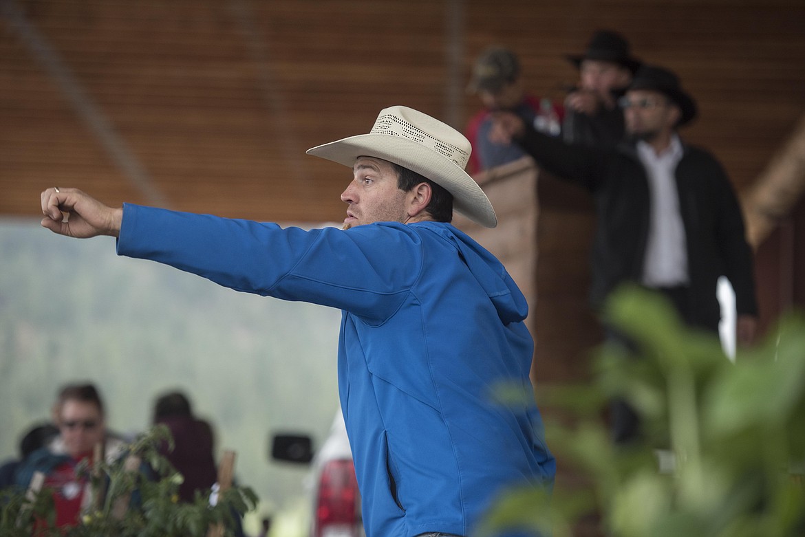 Stephen Girod looks for bidders on pots and plants during the annual amish Eagle Valley Community Auction, May 18. (Luke Hollister/The Western News)