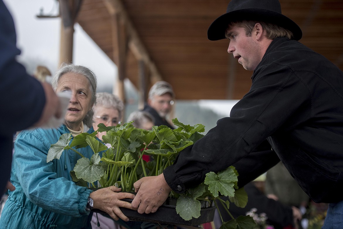 Judy Harding, left, wins a bid on a bundle of plants during the annual amish Eagle Valley Community Auction, May 18. (Luke Hollister/The Western News)