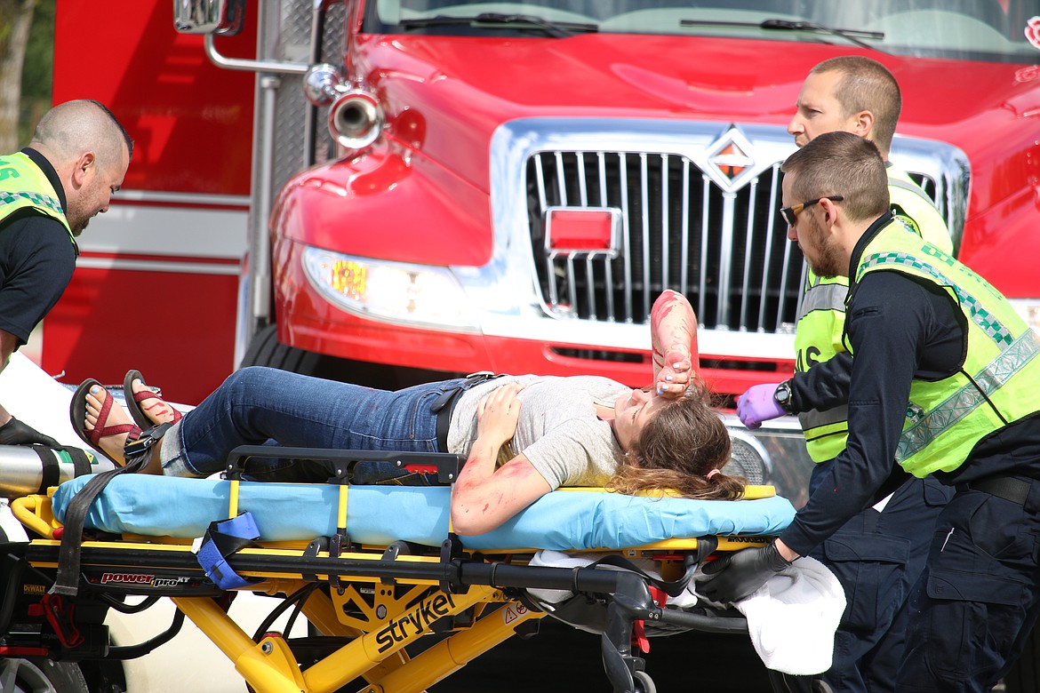 (Photo by MARY MALONE)
Clark Fork High School senior Grace Shelton is transported on a stretcher to an ambulance during the mock DUI scenario, &quot;Operation Grad Night,&quot; Tuesday at Sandpoint High School.