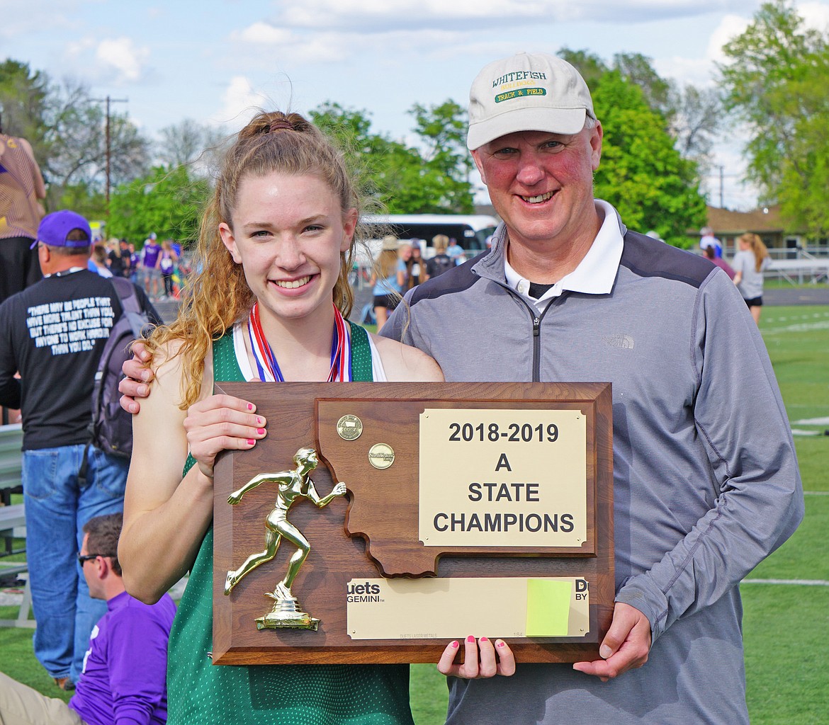 Bulldogs Head Track Coach Derek Schulz, along with his daughter Lauren, hold the championship plaque. (Photo courtesy Matt Weller)