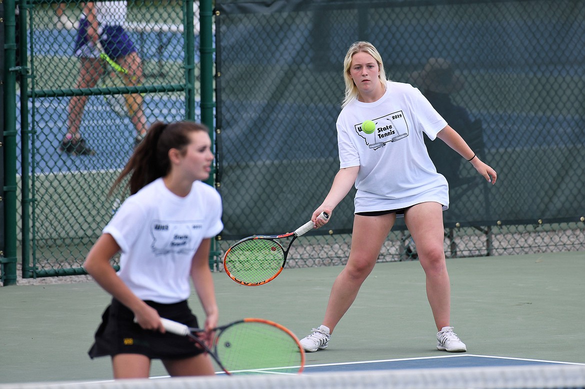 Bulldog Aubrey Hanks returns the ball with teammate Olivia Pothoff during doubles play in the Class A state tennis tournament last week at Flathead Valley Community College. Hanks and Pothoff earned the state doubles title. (Photo courtesy Jeff Doorn)