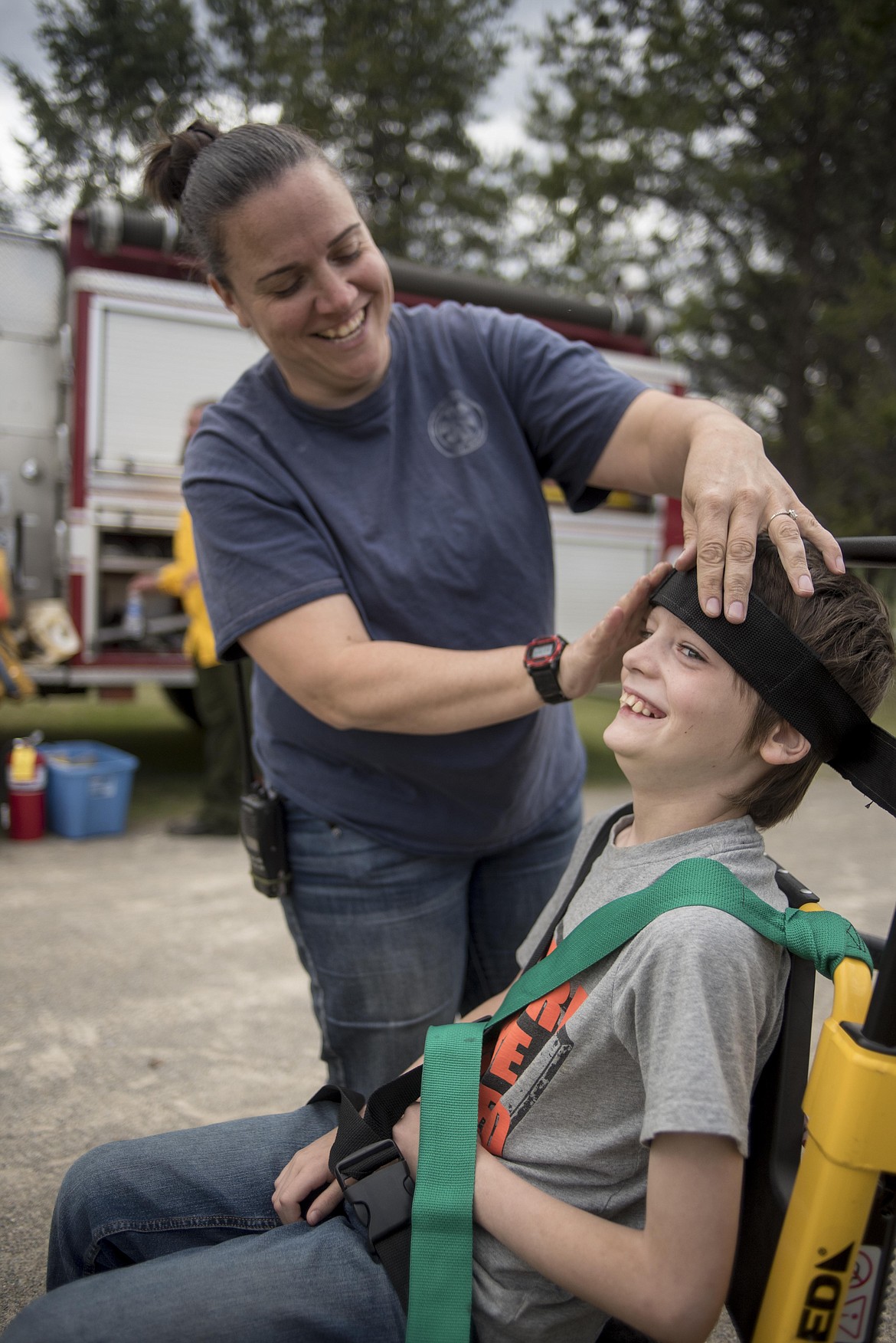 Troy Volunteer Ambulance member Amy Snow straps Gavin Thurston into a stair chair, Wednesday at the McCormick School Rendezvous. (Luke Hollister/The Western News)