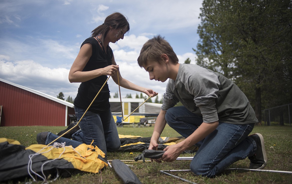 Nikki Eide, left, helps Frank Kortangian set up a tent, Wednesday at the McCormick School Rendezvous. During the outdoor learning program, students will spend a night outside. (Luke Hollister/The Western News)