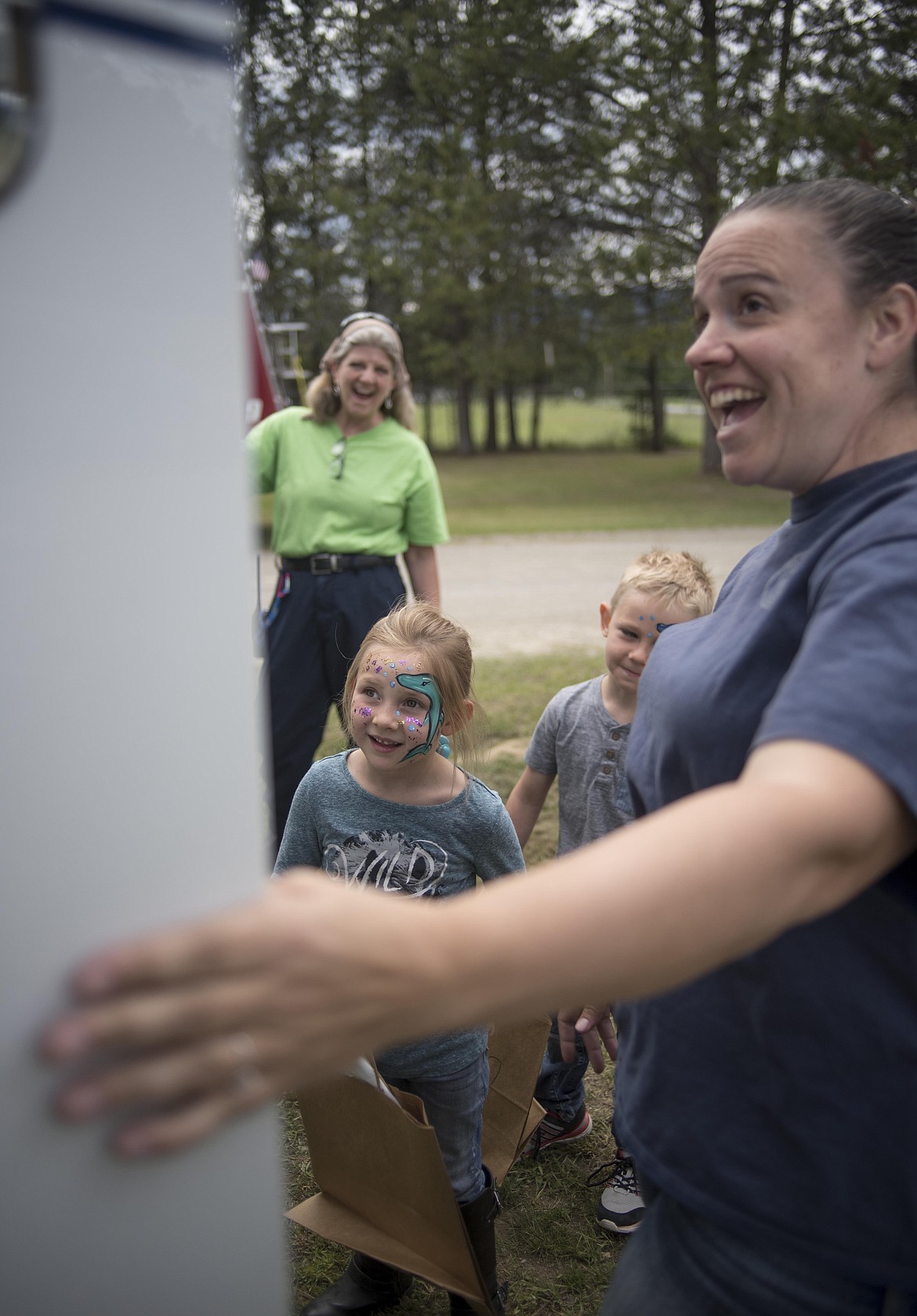 Troy Volunteer Ambulance staff, Janet Miller, left, and Amy Snow right, show Sybil Tucker, middle, the oxygen tank inside of their ambulance, Wednesday at the McCormick School Rendezvous. (Luke Hollister/The Western News)