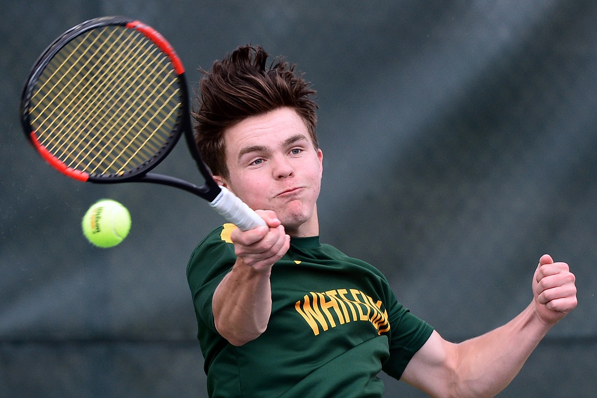 Whitefish&#146;s Brendan Buls hits a return against Libby&#146;s Zack Morrison in the Northwestern A Divisionals at Flathead Valley Community College on Thursday. (Casey Kreider/Daily Inter Lake)