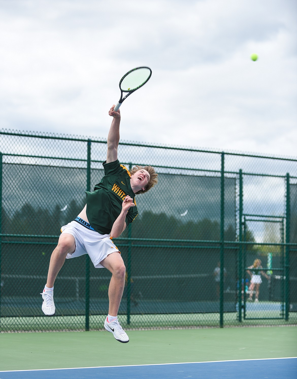 Colter Upton rises for the serve during the Western A Divisional Tournament last week at Flathead Valley Community College. (Daniel McKay/Whitefish Pilot)