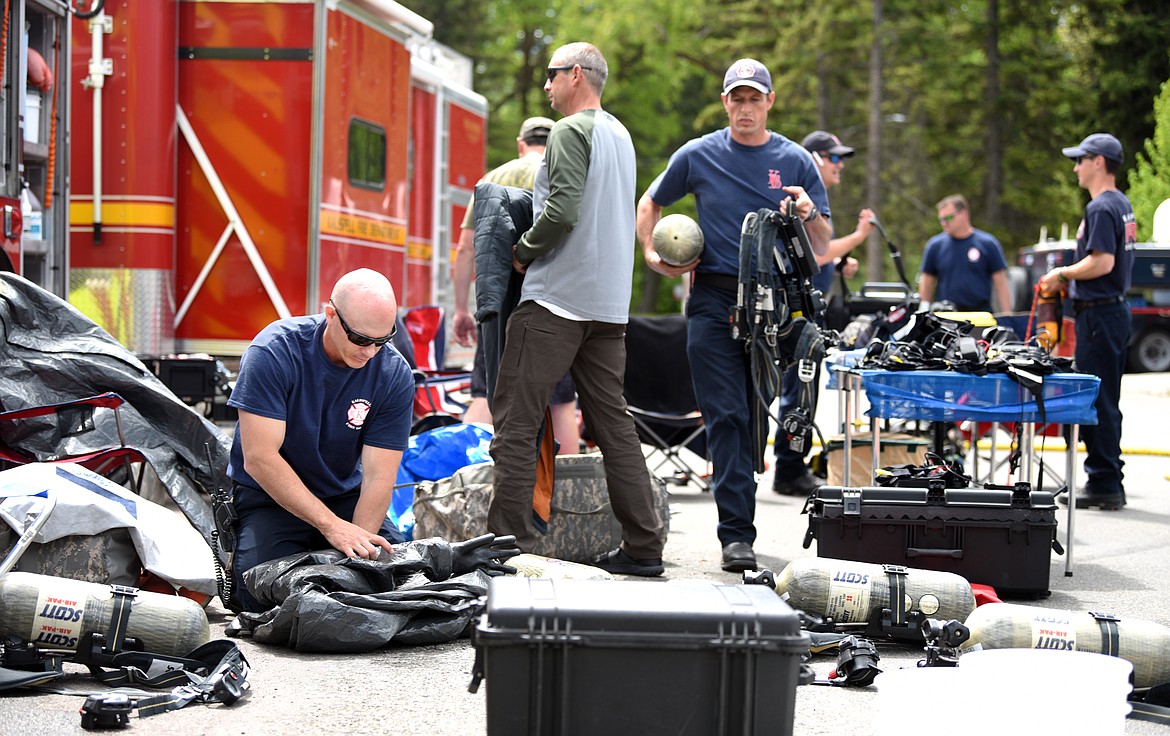 Jason Schwager and members of the Kalispell Fire Department pack and reload their HAZMAT gear on day one of a two day training with the Montana National Guard 83rd Civil Support Team. Today the two teams will be formulating a response to a scenario being staged on the Flathead Valley Community College property.(Brenda Ahearn/Daily Inter Lake)