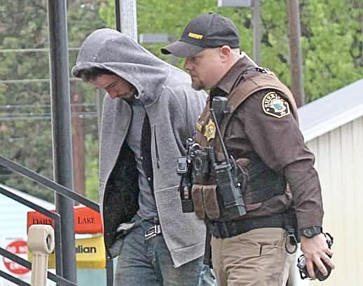 Shortly after Eugene Germain, 25, of Polson, was apprehended, Lincoln County Sheriff&#146;s Deputy James Derryberry escorts him into the Lincoln County Detention Facility. (Paul Seivers/The Western News)