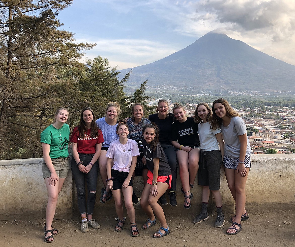 Laney Conger (second from far right) and her fellow Interact Club travelers pose for a photo with the Acatenango volcano looming in the background. The group spent a week in Guatemala last month working with Maya Pedal. (photo provided)