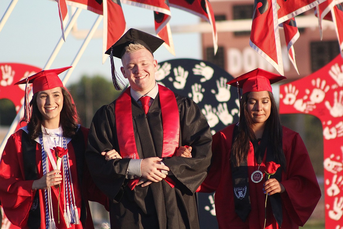 File photo
Othello High School seniors enter Huskie Stadium for the final time during a past graduation ceremony.