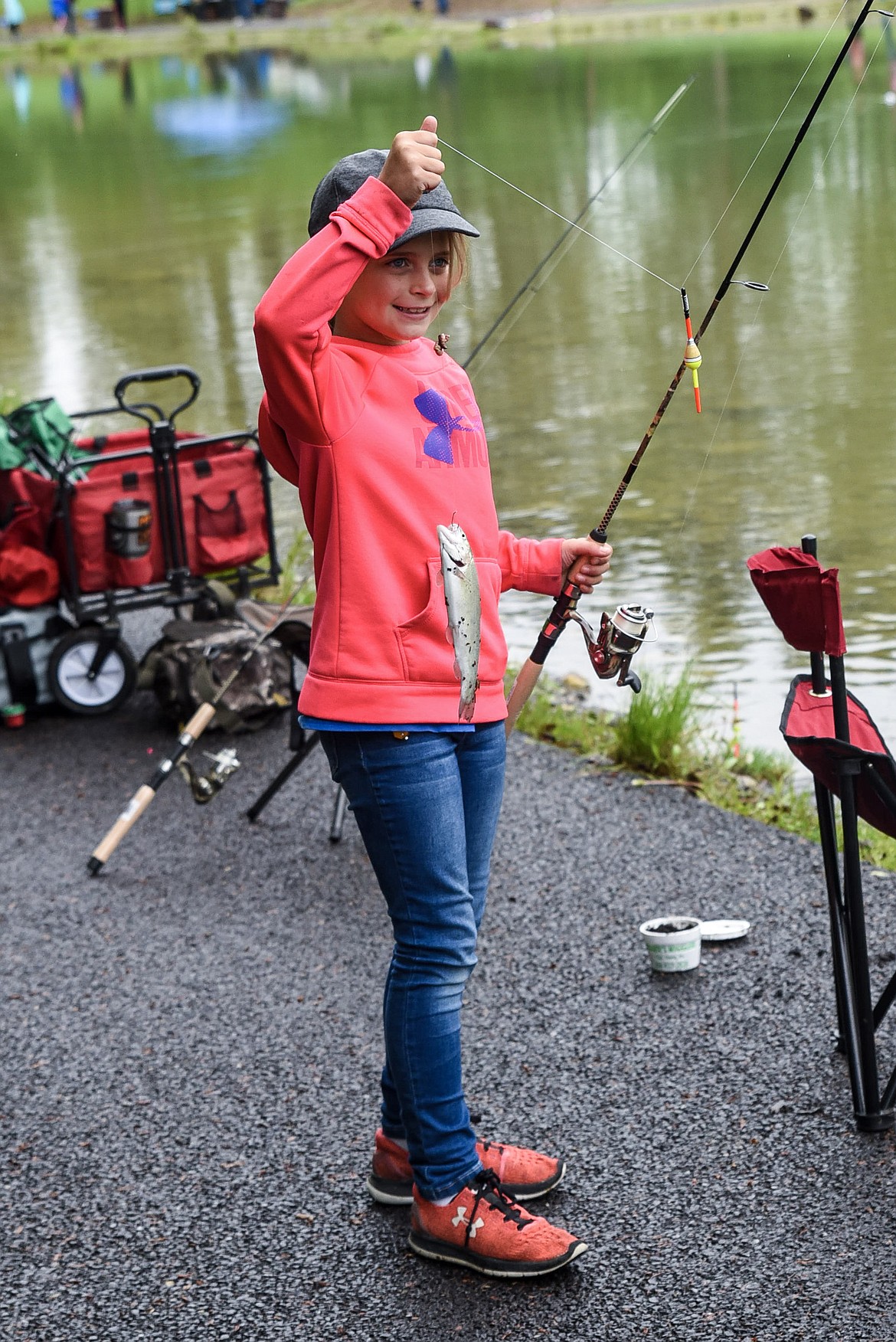 Teighler Parker holds up her catch at the Lil&#146; Anglers Fishing Day at the Mill Pond on Saturday (Ben Kibbey/The Western News)