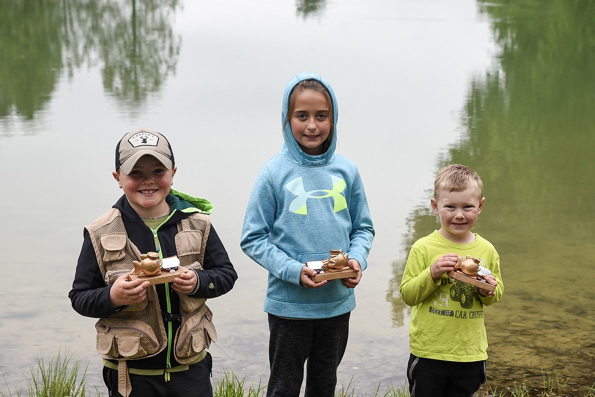 Liam Sunell, Cyleigh Parker and John Deitrick pose with their trophies at the Lil&#146; Anglers Fishing Day at the Mill Pond on Saturday (Ben Kibbey/The Western News)
