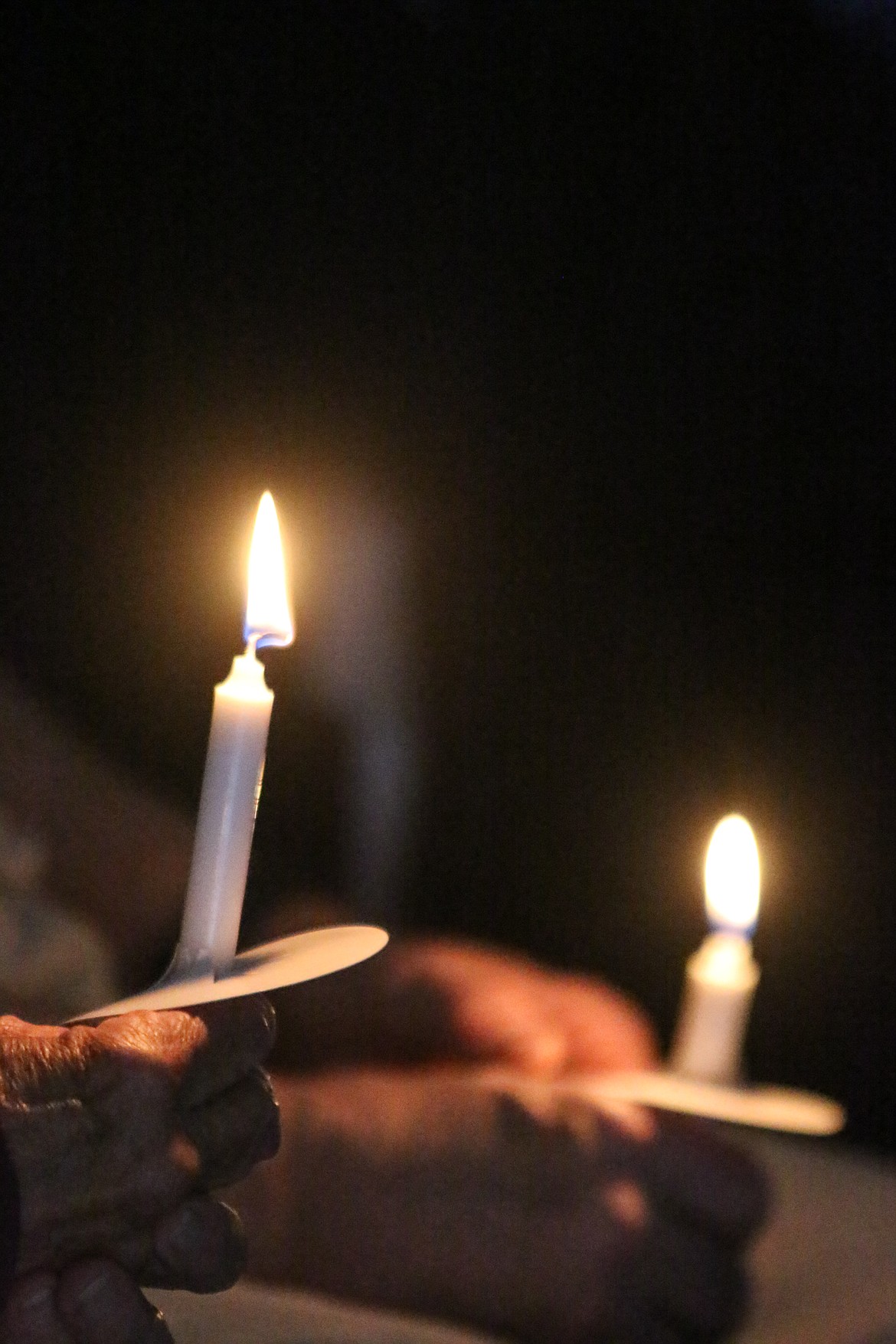 Photo by MANDI BATEMAN
Flames were passed from candle to candle during the National Peace Officer Memorial Observance.