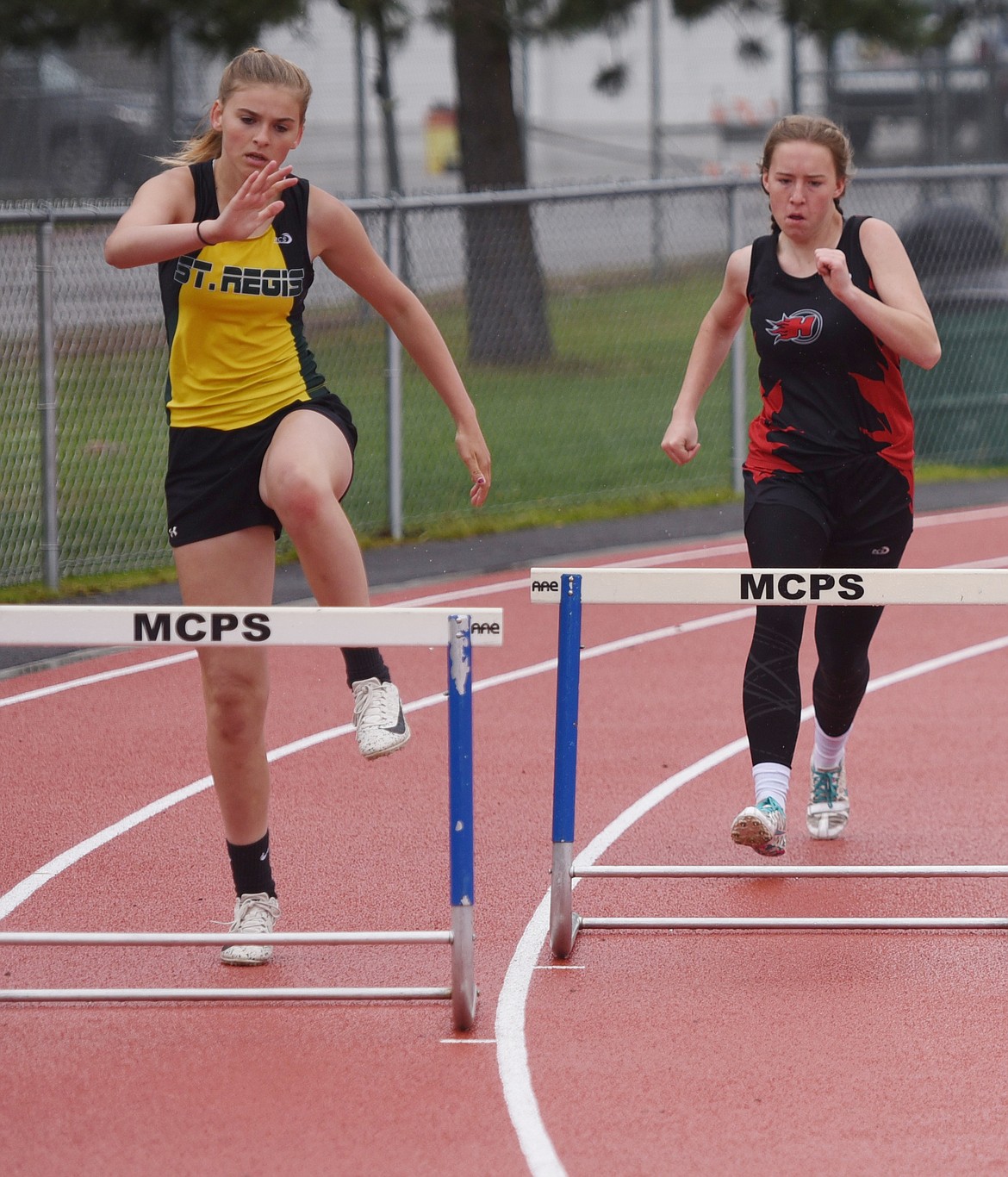 SUNNY SHOUPE, left, competes in the 300-meter hurdles event at Divisionals on Friday, May 17. (Joe Sova/Mineral Independent)