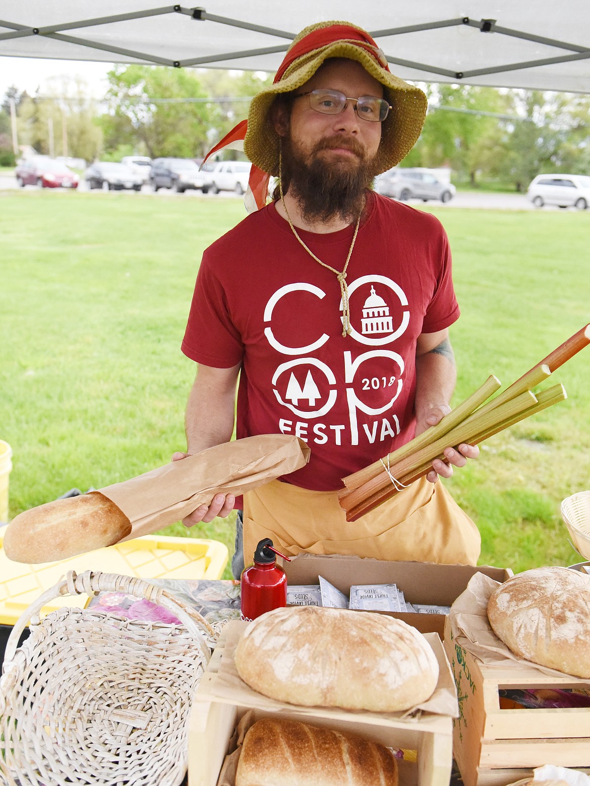 ZACH JOHNSON of Ronan brought some of his best organic bread to the farmers market. He is the owner of Crow&#146;s View Organic Farm. Above, Johnson shows his best sourdough bread and rhubarb.