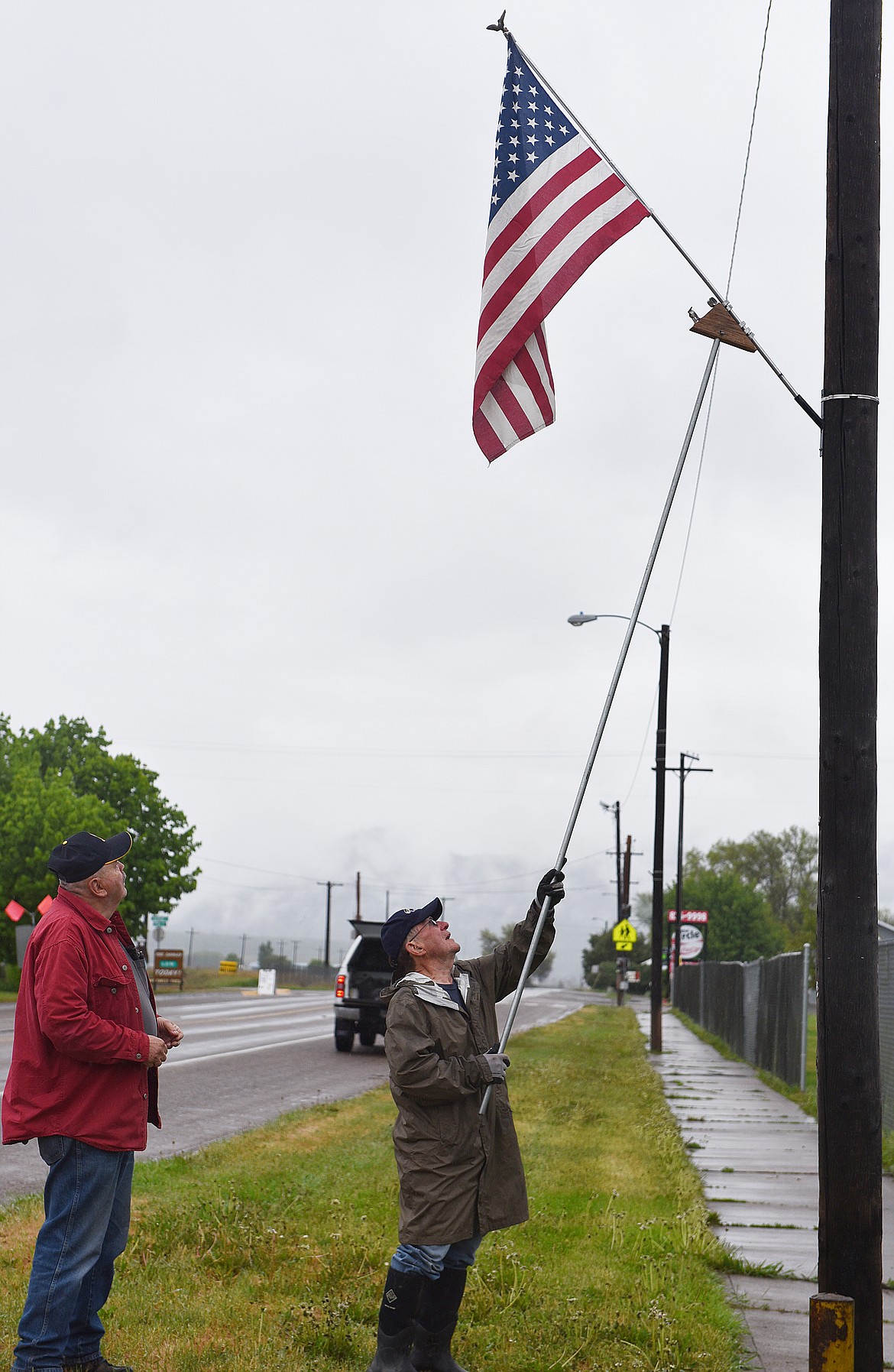 TWO NAVY vets, Bill Beck, left, and Joe Eisenbrandt quietly spruce up Plains in the early morning hours of Armed Forces Day last Saturday in advance of Memorial Day. (Carolyn Hidy photos/Clark Fork Valley Press)