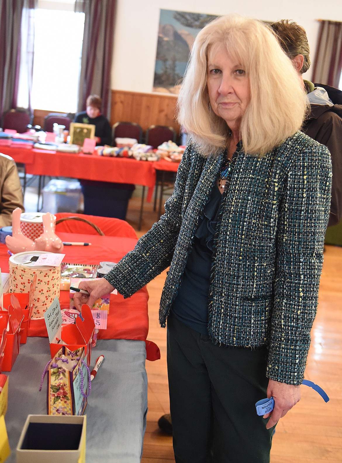 RONDA JORGENSON of Columbia Falls uses raffle tickets to make her choice of the prizes she wanted to win during the Cherry Blossom Festival