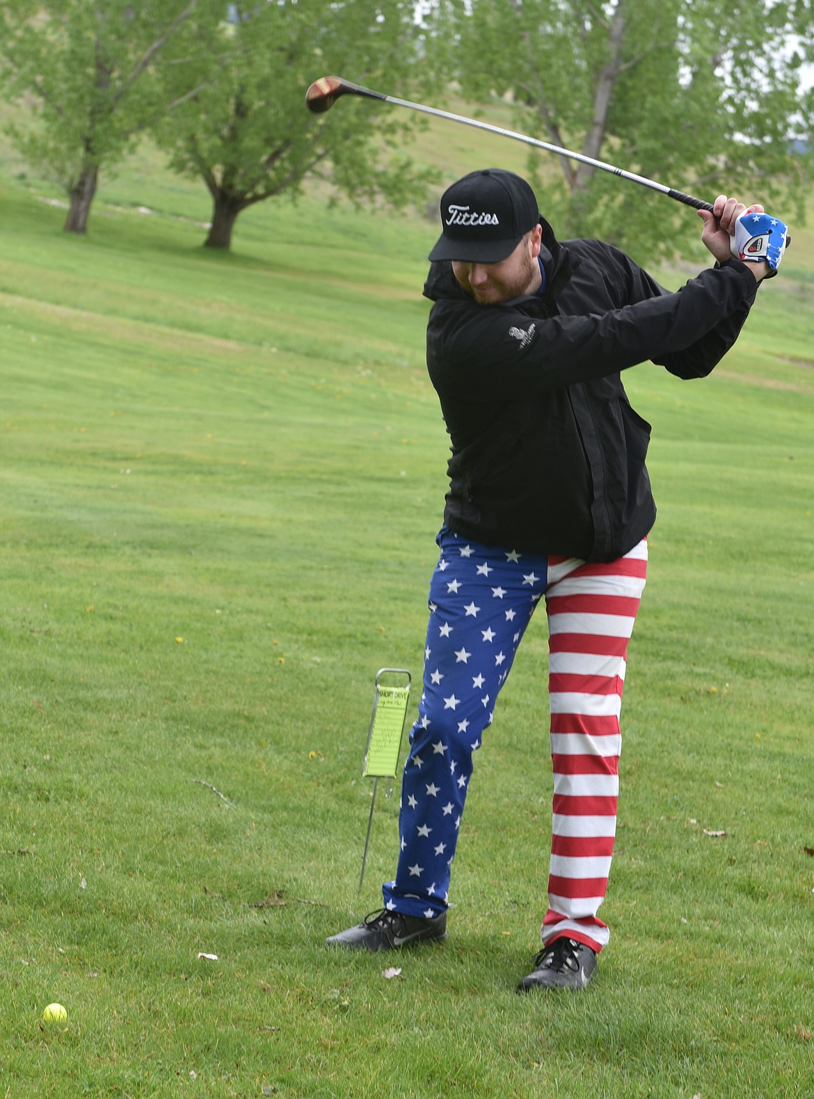 SAM WILKINS wore the most colorful attire during the Hack and Blast tournament Saturday in Plains. He swings a club above, but got the award for the &#147;Longest Drive with a Bat.&#148; (Carolyn Hidy photos/Clark Fork Valley Press)