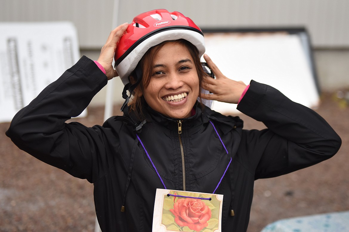 YULIYANAH REED of Ronan fits a new helmet before embarking upon the Mission Mountain Family Pedal to Plate on Saturday, May 18 in Ronan.